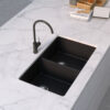 Forio 813 black quartz double bowl sink undermounted in a white marble benchtop with a matching black mixer