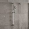 Coen 3 function shower on rail in chrome installed on a grey tiled shower wall with hand piece and inlet elbow