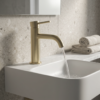 Lucito Curved Basin Mixer In Brushed Brass on a wall basin