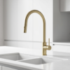 Lucito Gooseneck Pull Out Sink Mixer In Brushed Brass on a kitchen sink